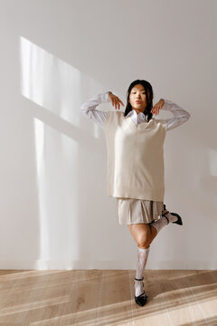 Trendy model dancing in sunlight