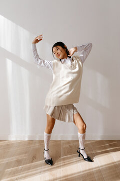 Modern ethnic model dancing in sunlight