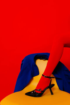 Crop woman in red stocking and shoes