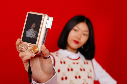 Model taking selfie with digicam