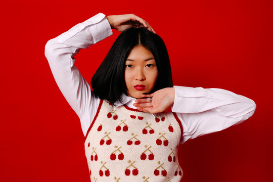 Cool ethnic woman at red wall