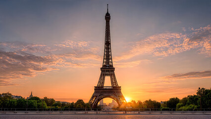 Obraz premium Eiffel tower silhouetted against a golden sunset sky