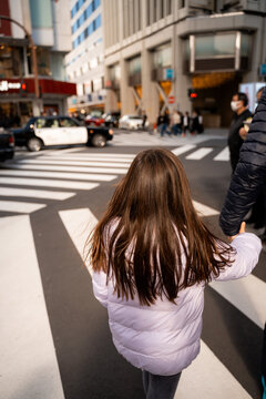 Young Girl Crossing Busy Street. Tokyo, Japan