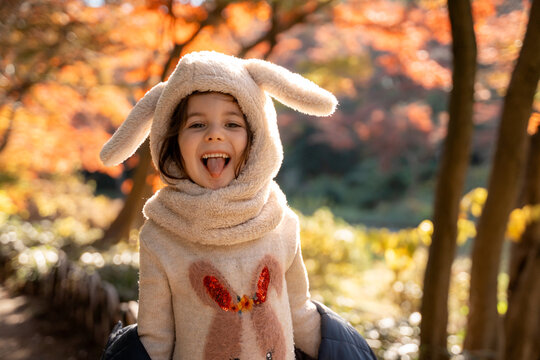 Happy Child in Autumn Forest, Bunny Outfit