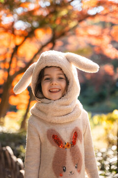Happy Child in Autumn Forest, Bunny Outfit