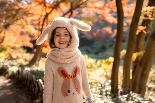 Happy Child in Autumn Forest, Bunny Outfit