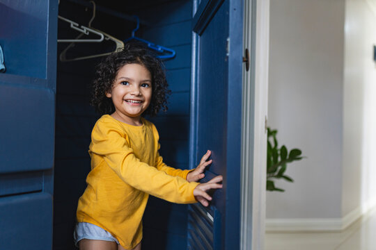 Happy girl coming out of the closet