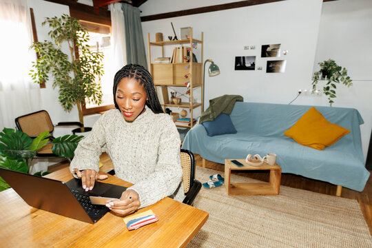Smiling Woman shopping online using credit card