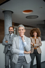 Diverse business team smiling confidently in modern office