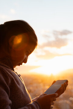 Girl Using mobile at Sunset 