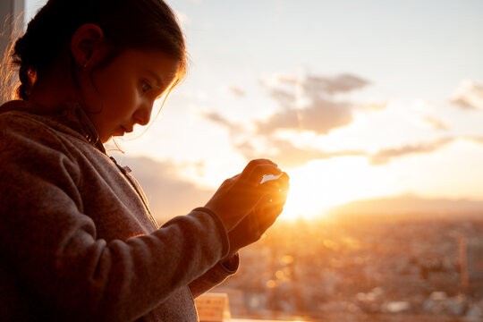 Young Girl Using Smartphone at Sunset