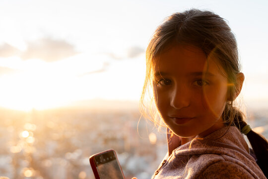 Girl Using mobile at Sunset 