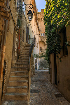 Picturesque street lined with traditional Mediterranean houses in the medieval hilltop village Haut de Cagnes in Cagnes sur Mer, South of France