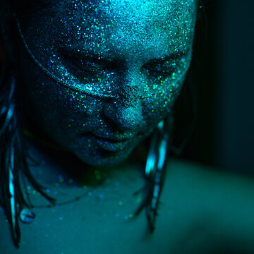 Glitter-adorned woman with facial jewelry
