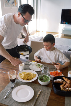 Family eating lunch together at dining table