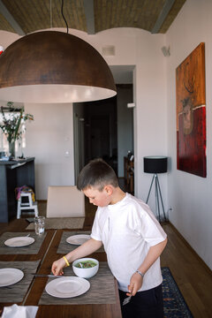 Mother and son setting the dining table