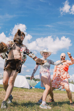 People Dancing in Creative Costumes at Outdoor Festival