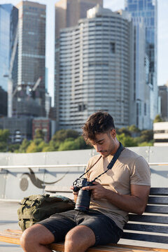 A young man focus on his camera in Melbourne Australia