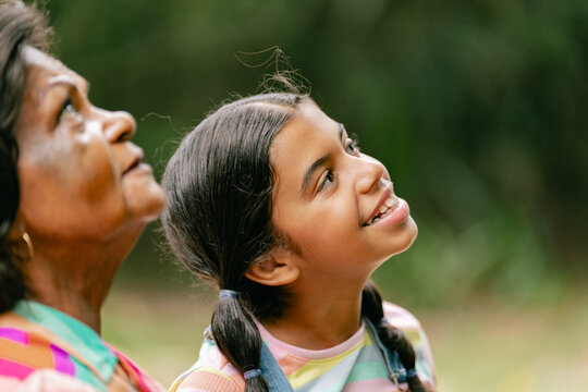 grandfather walking in the park with his beloved granddaughter