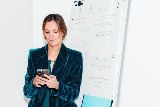 Executive businesswoman using phone at the office