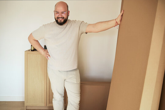 Man posing proudly with a furniture box