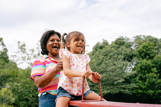 Grandmother and Granddaughter on a Seesaw