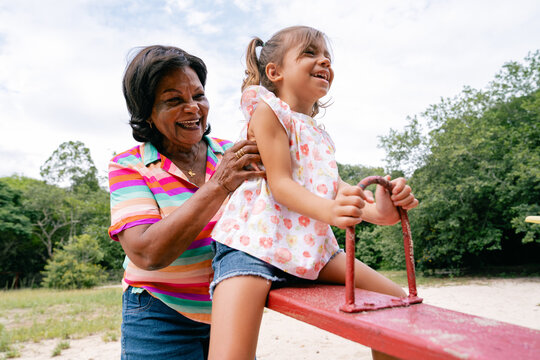 Grandmother and Granddaughter Enjoying a Teeter-Totter