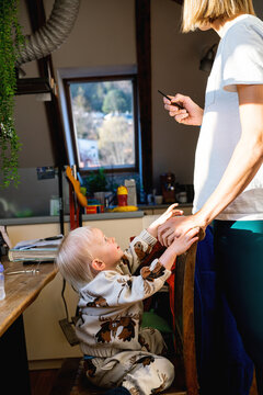 Mother about to comb childs hair 