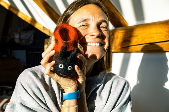 Mother showing her little daughters shoe 