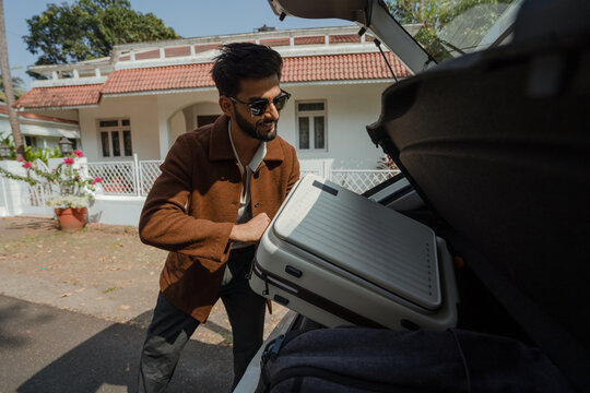  Man Loading a Suitcase at the Driveway