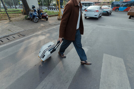 Man Crossing Street with Luggage
