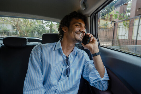 Man having Joyful Phone Conversation in the car