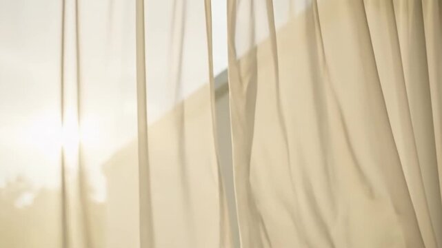 Soft silk fabric with a blue and gray pattern creates a smooth texture of lines and light as the curtain hangs against the wall