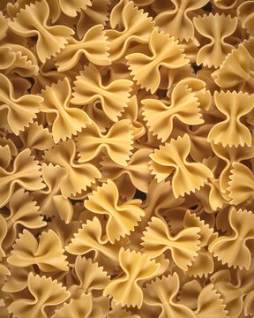 Seamless pattern of uncooked farfalle pasta texture background