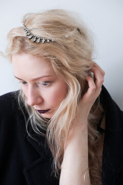 Elegant woman with long blonde hair and dark lipstick