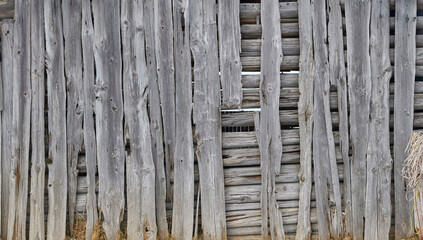 Old wooden hut with beautiful wooden beams in the mountains, close up.