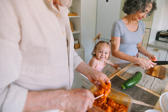 Toddler Watching Grandparents Cook