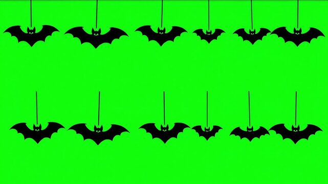 Hanging Bat Silhouettes on a Green Display