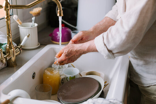 Washing Hands at Kitchen Sink