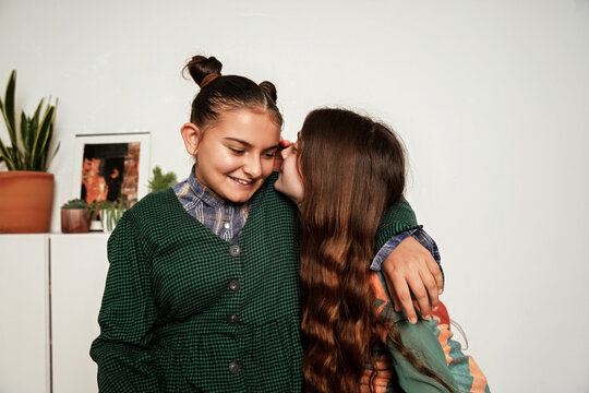 Friends whispering secrets 