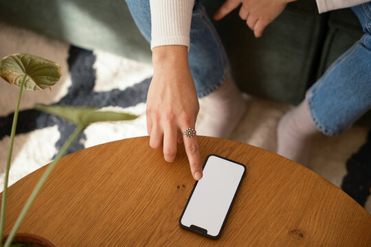 Anonymous woman using blank screen phone.