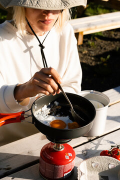A woman cooks on a camping trip