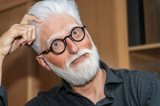 Playful Senior Man With White Beard And Glasses