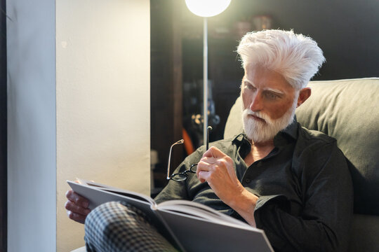 Elderly Man Reading And Thinking
