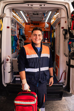 Paramedic smiling and holding first aid kit
