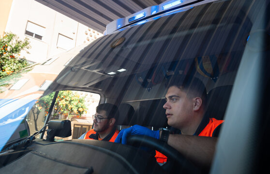 Paramedics driving ambulance during emergency service operation
