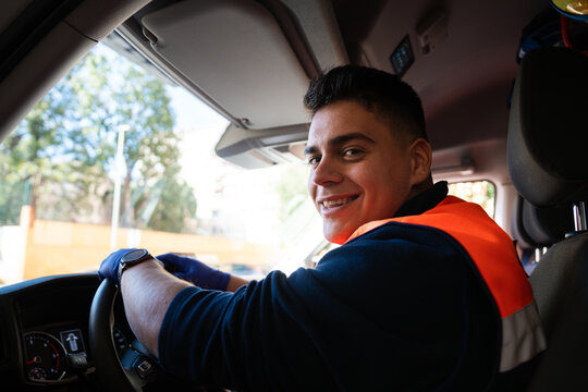 Paramedic smiling and driving ambulance
