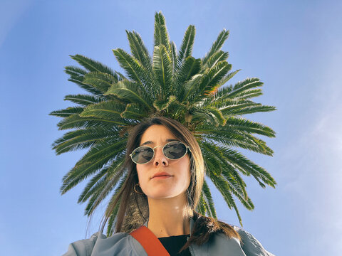 A creative low-angle portrait of a young woman 