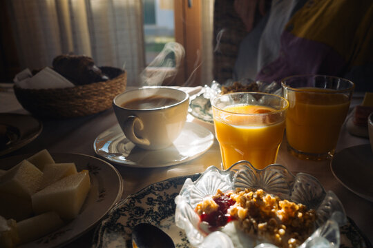 Warm breakfast with coffee and orange juice by the window