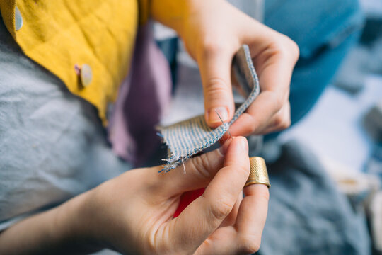 Close-up of hands sewing fabric